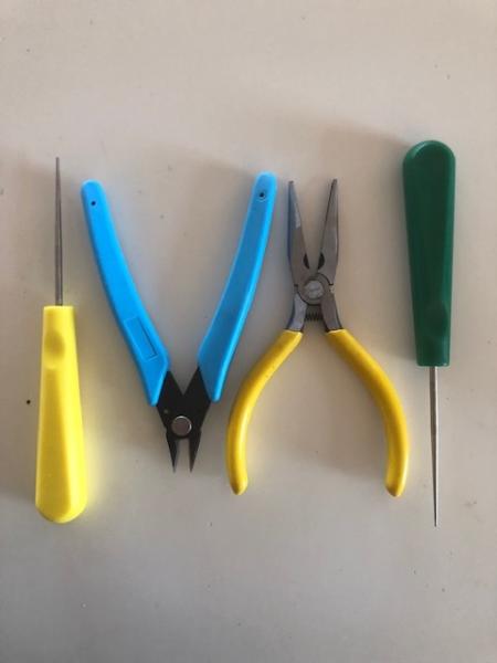 Four-piece stringing tool set with awls, pliers and side cutters